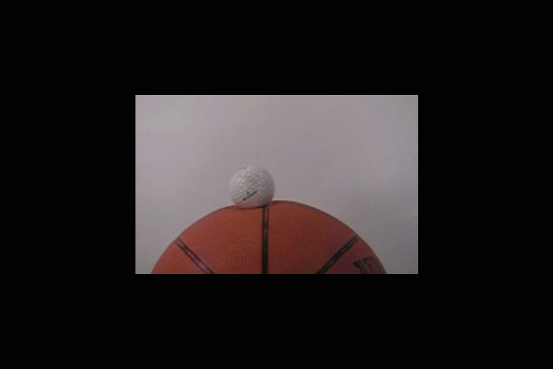 Image of a golf ball colliding with a basketball.