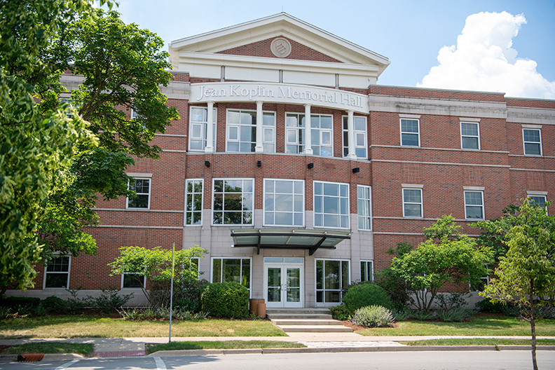 Brick building with a sign that reads "Jean Koplin Memorial Hall"