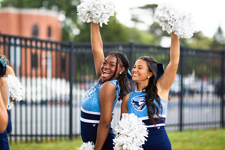 Two cheerleaders holding pompoms